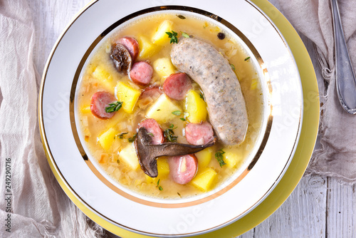 a polish easter soup with homemade white sausage and mushrooms photo