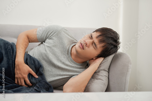 Sick man lying on the couch