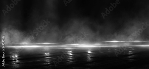 Foto Wet asphalt, reflection of neon lights, a searchlight, smoke