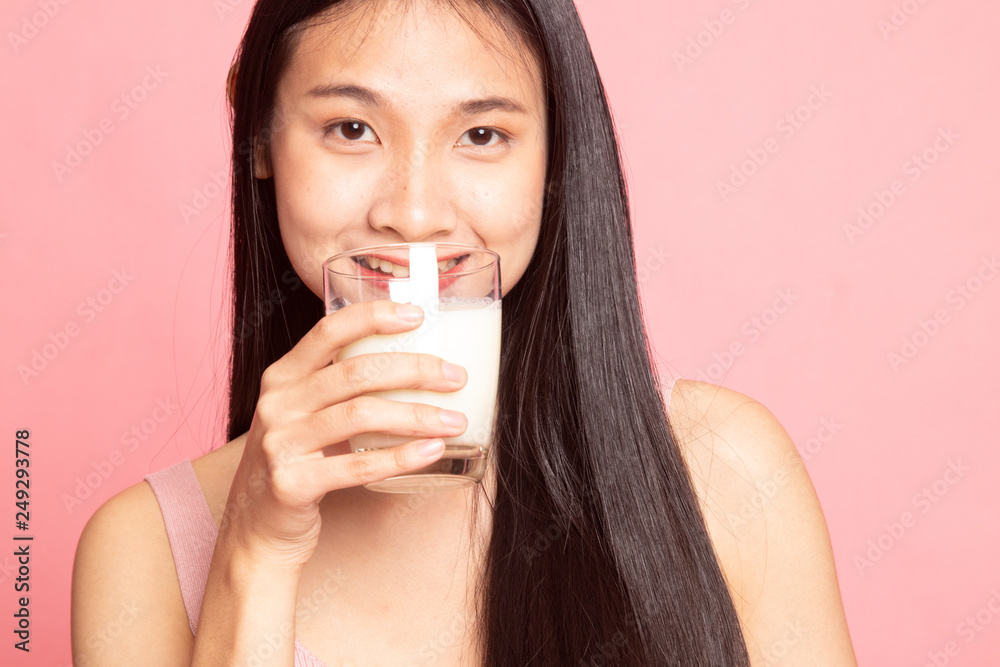 Healthy Asian woman drinking a glass of milk. Healthy Asian woman drinking a glass of milk.