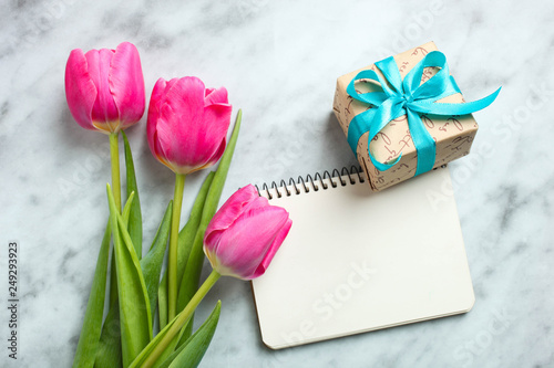 Bouquet of beautiful pink tulips and notebook