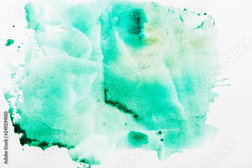 Top view of turquoise watercolor spill on white paper