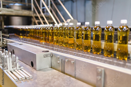 Bottling factory - Apple juice bottling line for processing and bottling juice into bottles. Selective focus.
