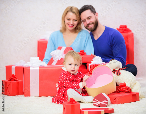 I believe in love. father, mother and doughter child. Love and trust in family. Bearded man and woman with little girl. Happy family with present box. Shopping. Boxing day. Valentines day. Red boxes