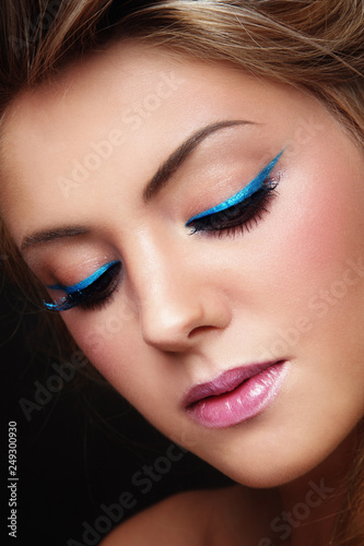 Close-up portrait of young beautiful girl with fancy winged eye make-up