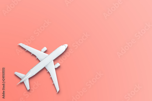 Toy model airplane design miniature on bight living coral background. The idea of tickets for the trip, traveling by plane, new discoveries, summer holidays © aapsky