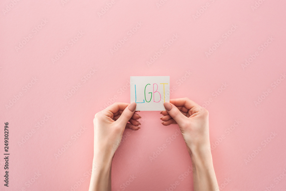cropped view of woman holding card with cropped view of woman holding card with
