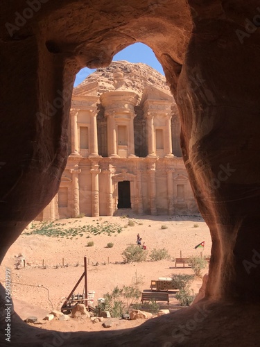 Evocative view of the monastery from a natural rock frame, Petra, Jordan