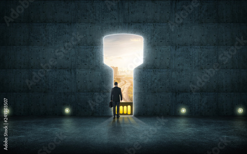 Fotografía Hesitant businessman stand on wall with digital usb key hole door ,sunrise scene city skyline outdoor view