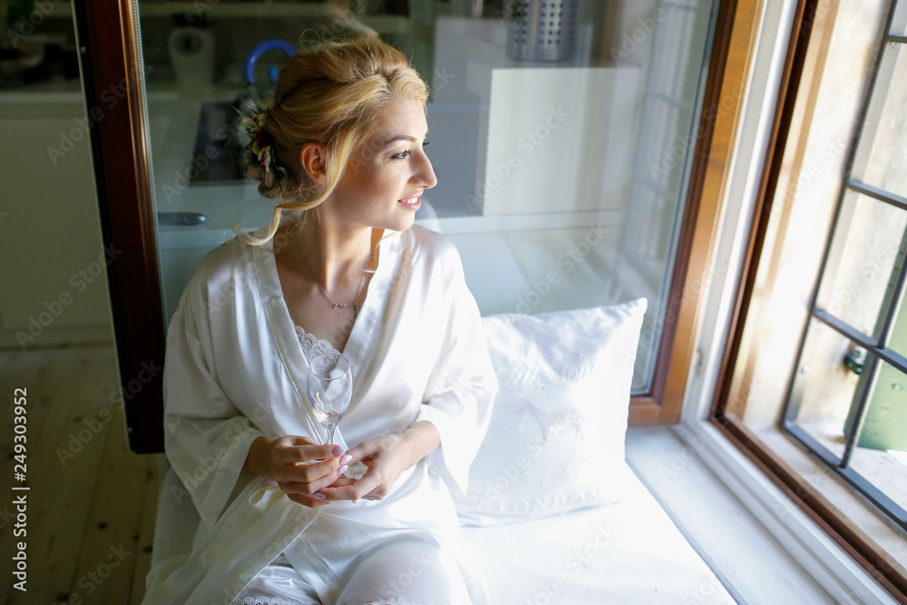 Beautiful blonde bride posing in hotel room Beautiful blonde bride posing in hotel room