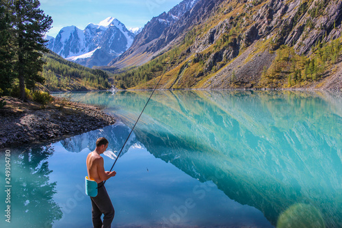 Man fishing in a mountain lake