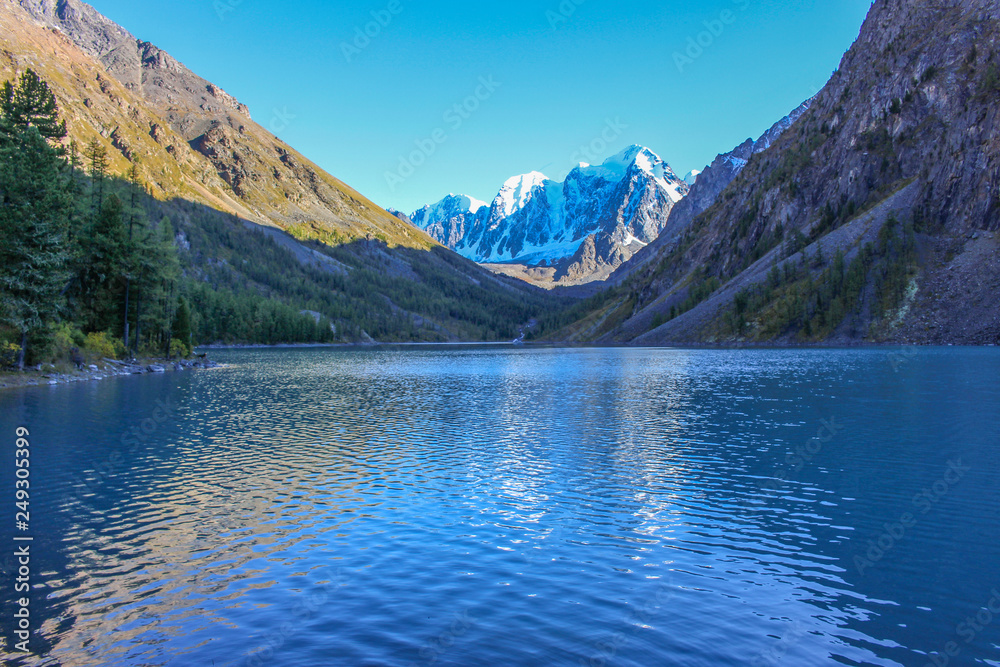 Mountain lake in autumn on the background of snow-white peaks