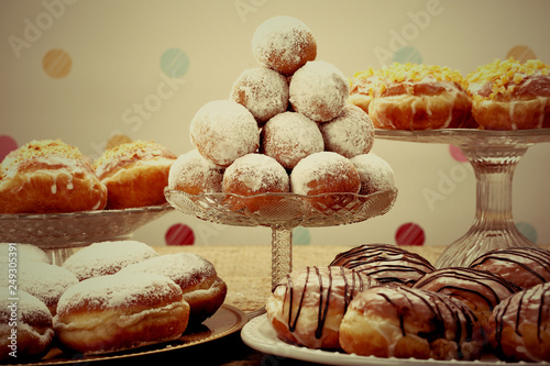 Sweet donuts on rustic wooden table, close up vintage view photo