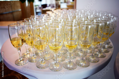 Glasses with champagne on white table