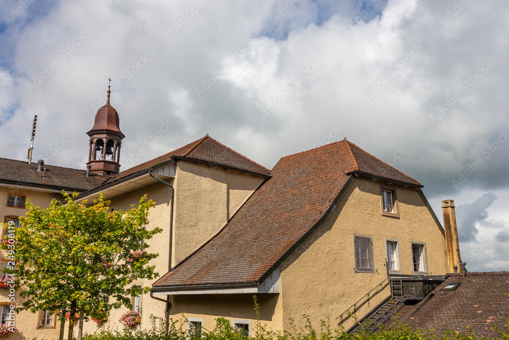 Old houses with tiled roofs and turrets against a cloudy sky in Bern, Switzerland