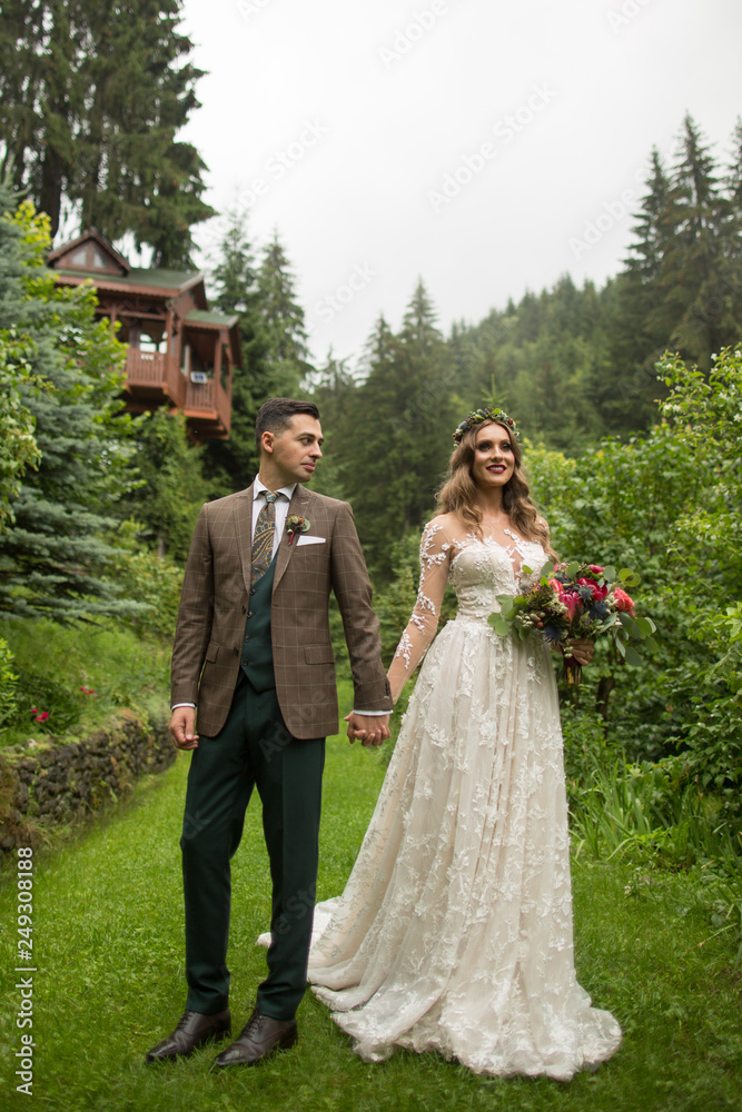 Beautiful wedding couple posing outdoor in nature Beautiful wedding couple posing outdoor in nature