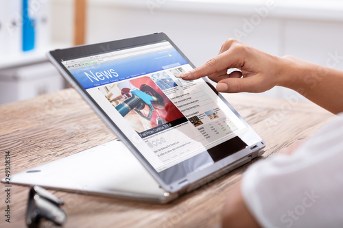 Woman Pointing The Finger At News On Laptop