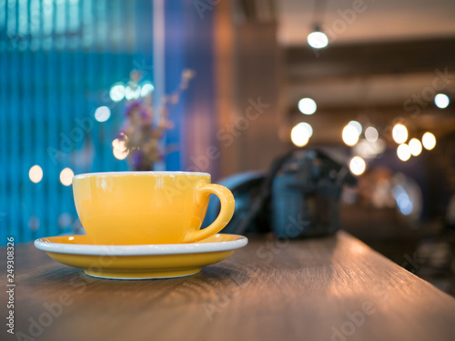 Yellow coffee cup on table, light bokeh background, photography background,