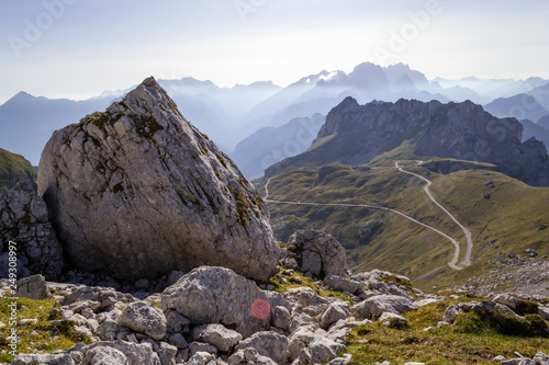 View of Mangart Saddle or Mangart Pass (Mangartsko sedlo or Mangrtsko sedlo), at 2,072 metres (6,798 ft) with the Mangart Road (Mangartska cesta) that leads to it, on a bright, Summer afternoon photo