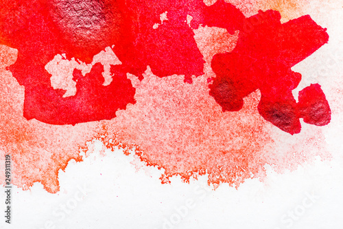 top view of red watercolor spill on white background with copy space