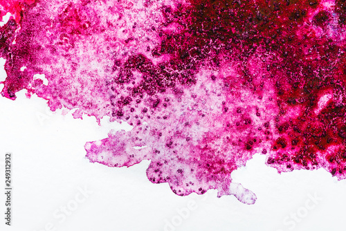 top view of pink watercolor spill on white background
