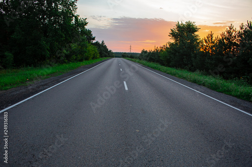 Empty straight road at sunrise