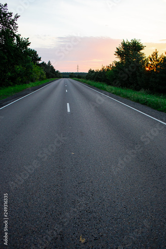 Empty straight road at sunrise