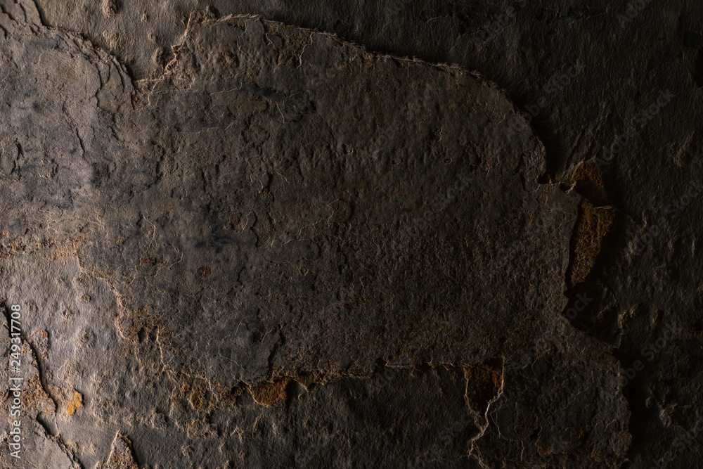 Beautiful grunge aged stone background with low light and strong texture. Beautiful grunge aged stone background with low light and strong texture.