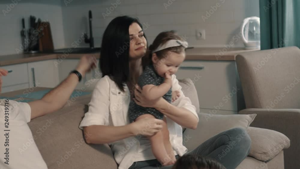 Happy family sitting on couch at home Happy family sitting on couch at home