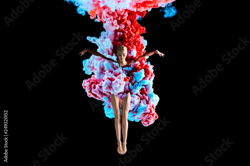Modern art collage. Concept ballerina with colorful smoke. Abstract formed by color dissolving in water on black background