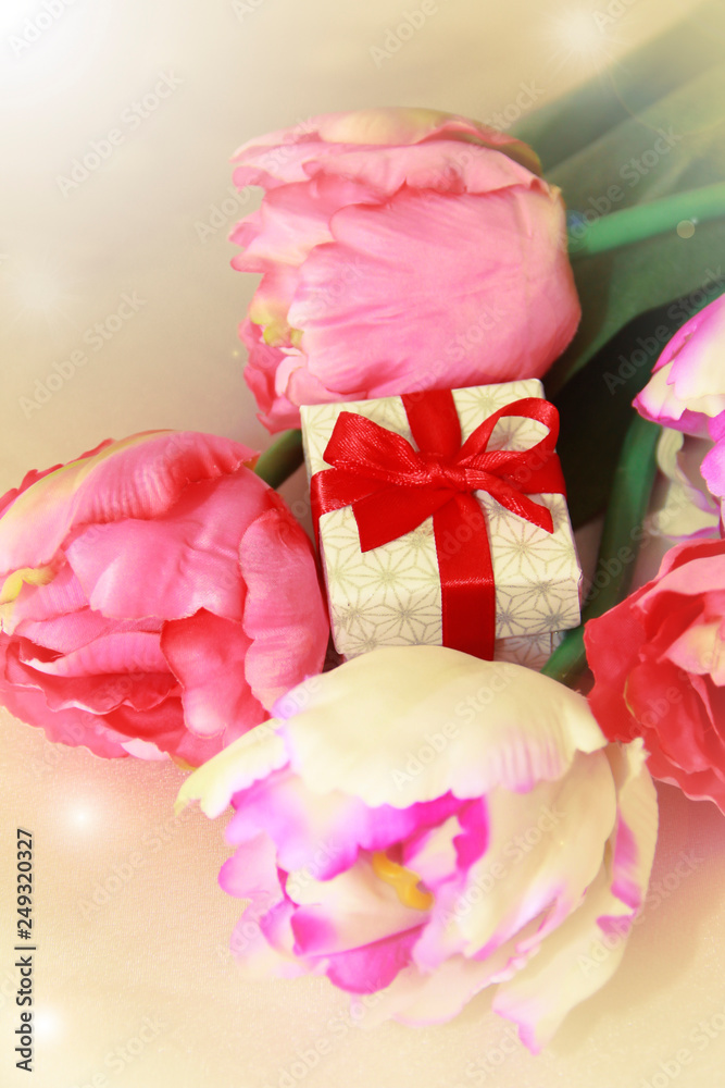 pink tulips and decorative gift box with a bow for the holiday of March 8 pink tulips and decorative gift box with a bow for the holiday of March 8