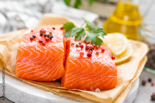 Fresh raw salmon fish fillet on white kitchen background