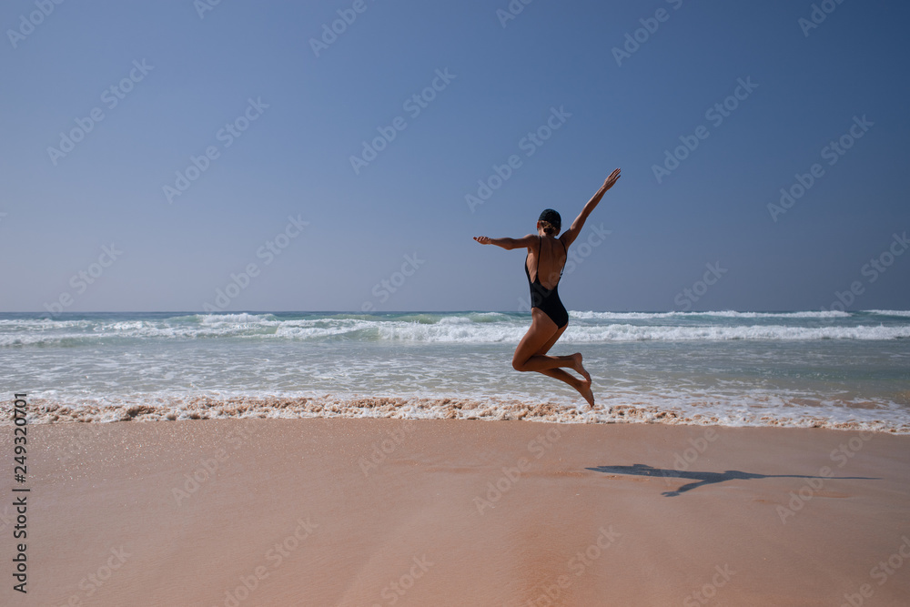 Happy girl jump on the beach