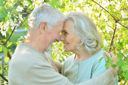 Portrait of happy senior couple resting in a park