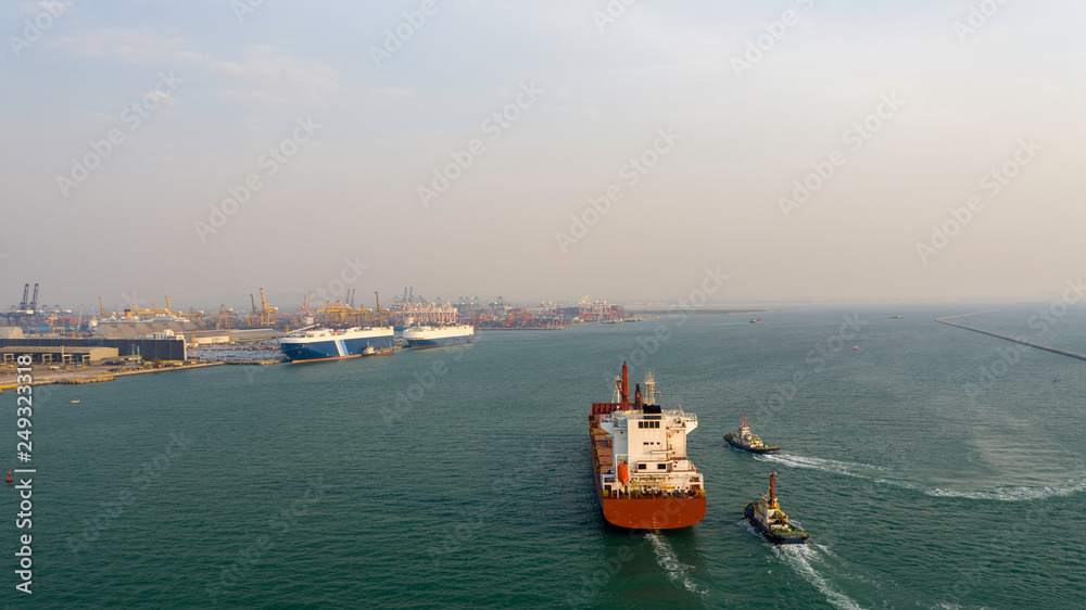 Aerial view. Container ship in pier with crane bridge carries out export and import business in the open sea. Logistics and transportation