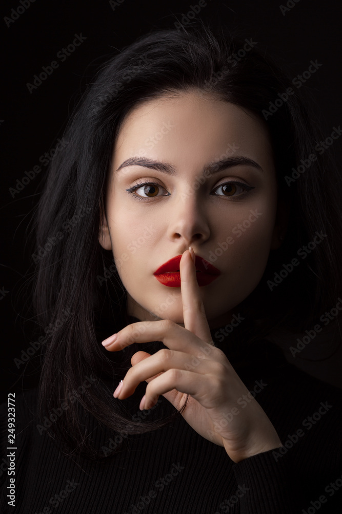 Hush be quiet woman isolated on black. Beautiful girl with finger on her lips. Hush be quiet woman isolated on black. Beautiful girl with finger on her lips.