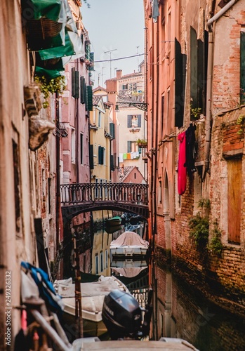 Colourful pink tenement houses and Grand Canal in Venice, Italy