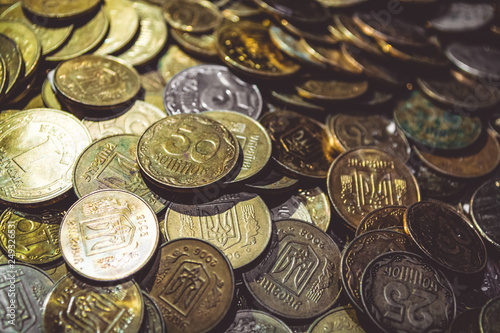 A lot of gold coins. Finance, business, money. Hryvnia. Profit. Currency. Texture and background.