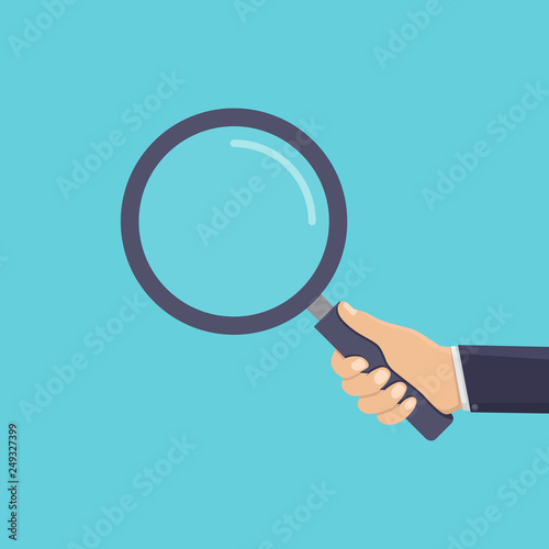 Business hand holding a magnifying glass, flat design vector illustration