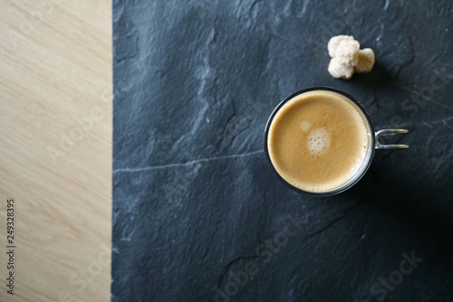Top view of freshly brewed coffee on slate with text space