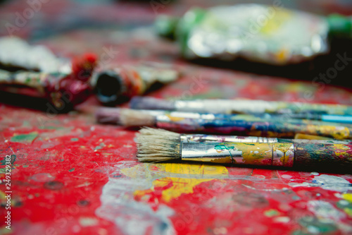 Painting brushes and oil on painter table