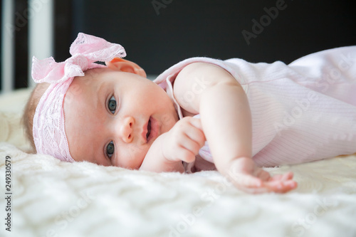adorable baby girl with pink bow