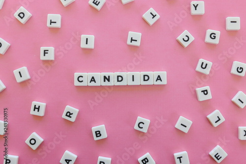 Obraz na płótnie Candida word made of square letter word on pink background.