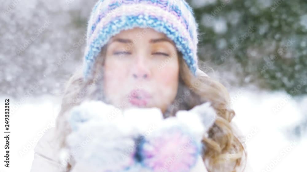 people, season and christmas concept - close up of happy young woman in winter forest blowing to snow people, season and christmas concept - close up of happy young woman in winter forest blowing to snow