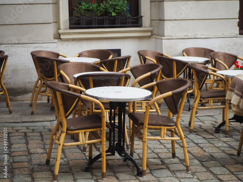 Empty tables in a street cafe in Lviv