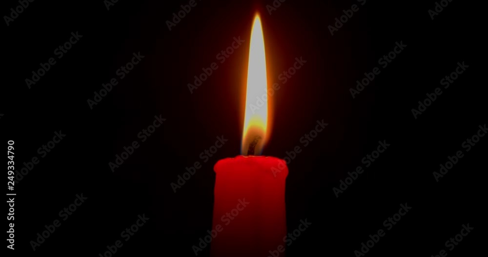 Burning red candle on a black background. Close-up, 4K. Burning red candle on a black background. Close-up, 4K.