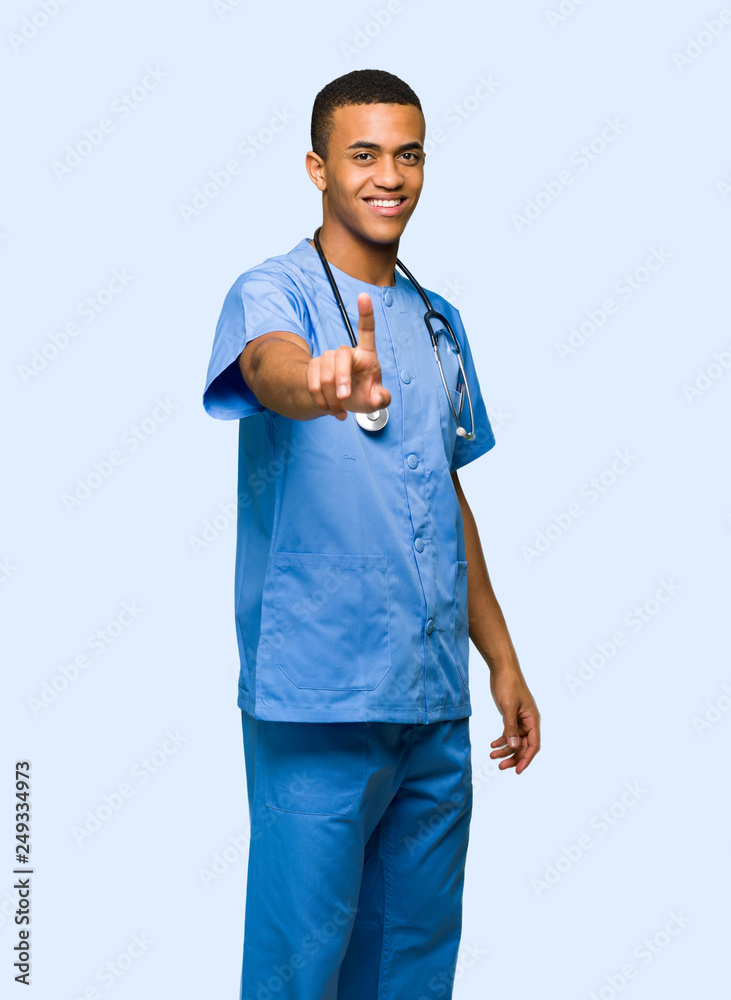 Surgeon doctor man showing and lifting a finger on isolated background Surgeon doctor man showing and lifting a finger on isolated background