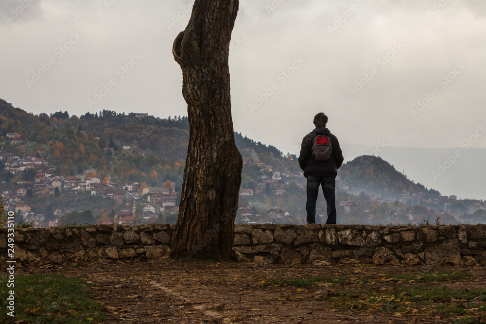 A man looks from a high point to the city of Sarajevo, which is located on the hills. Bosnia and Herzegovina