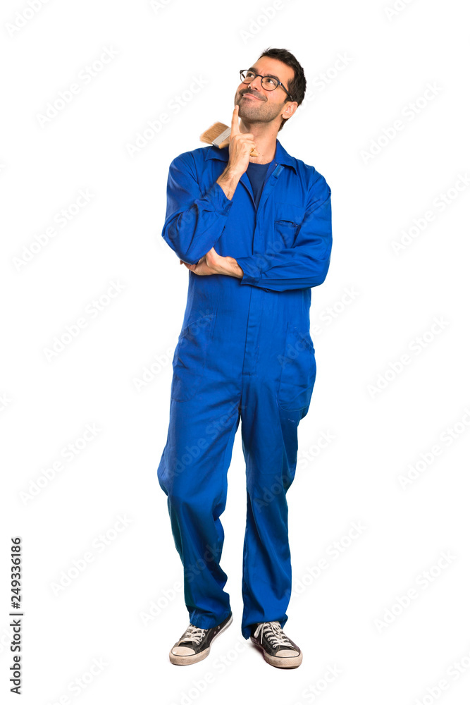 A full-length shot of a Painter man thinking an idea while looking up on isolated white background A full-length shot of a Painter man thinking an idea while looking up on isolated white background