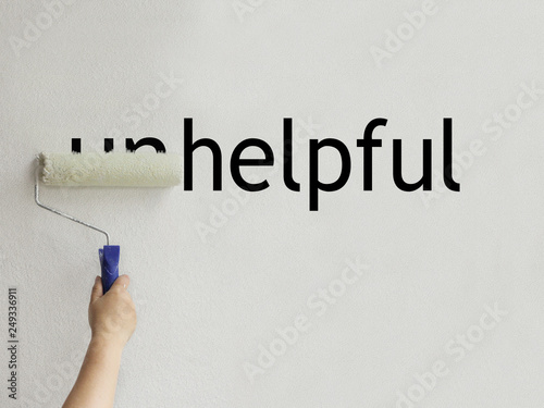 the word unhelpful is filled with white paint and becomes helpful photo